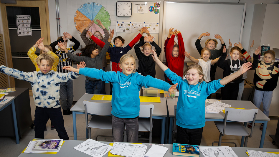 Lågstadieelever som gör rörelser i klassrum.