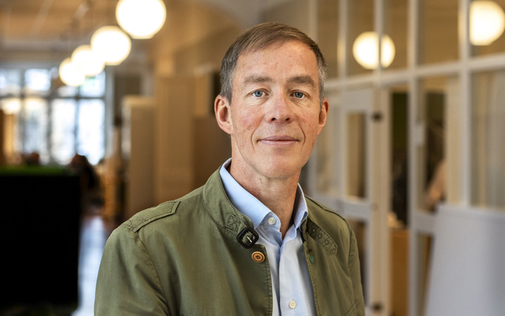 Närbild på en man som står i en skolkorridor.